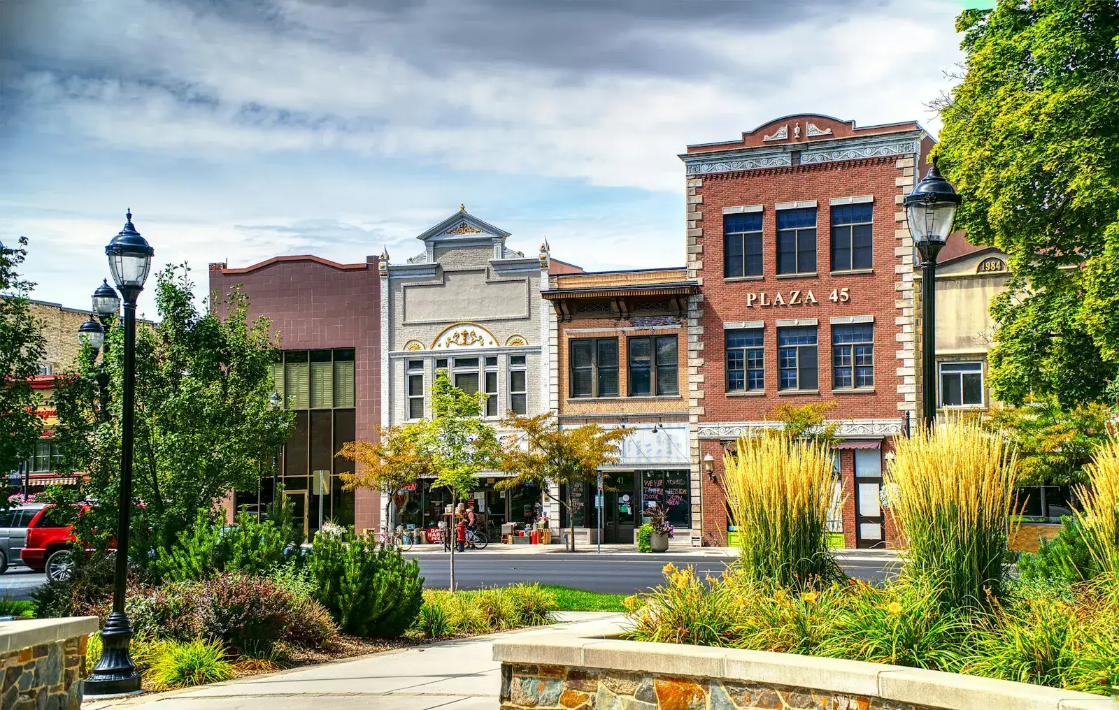 Brick storefronts and lamp posts along a small-town main street